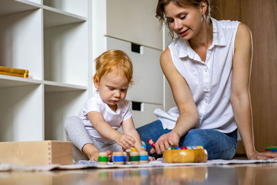 Happy mother and son sitting at home