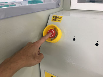 Midsection of man holding yellow sign