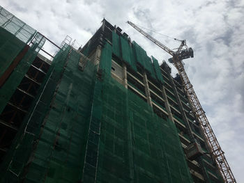 Low angle view of building under construction against sky