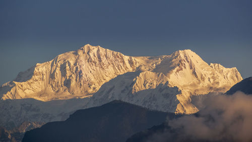 Scenic view of snowcapped mountains against clear sky