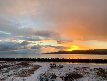 Scenic view of sea against romantic sky at sunset
