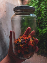 Close-up of hand holding glass jar