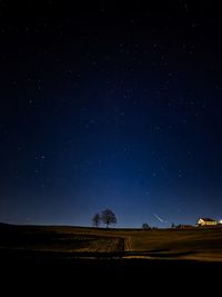 Scenic view of landscape against sky at night