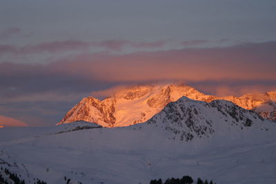 Scenic view of snowcapped mountains against sky during sunset
