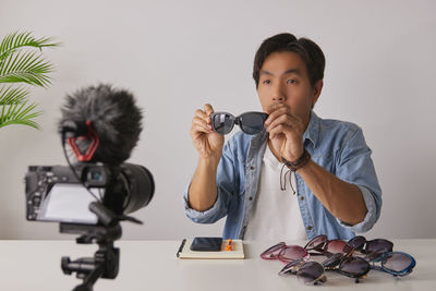 Portrait of boy photographing on table