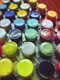 High angle view of multi colored bottles on table