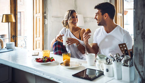 Young couple holding ice cream