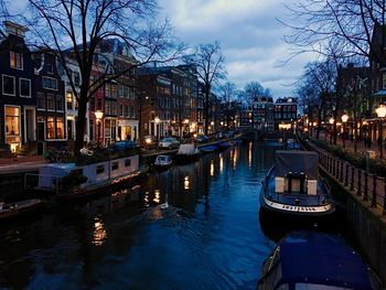 Boats in river with buildings in background