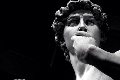 Close-up of statue against black background