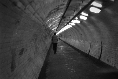Rear view of man in tunnel