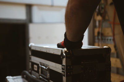 Cropped hand of man with metal container on stage