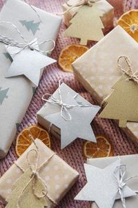 Christmas presents on pink knitted textile background. 