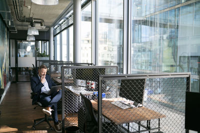 Man sitting in front of glass window