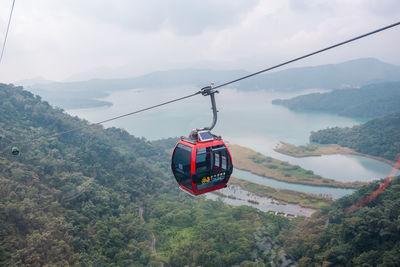 Overhead cable cars against mountains