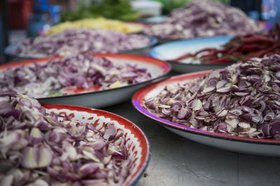 Close-up of onions in containers on table