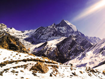 Scenic view of snowcapped mountains against clear sky