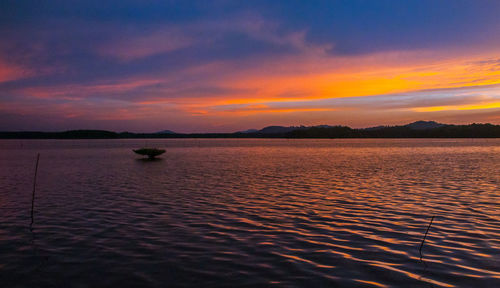 Scenic view of lake against romantic sky at sunset