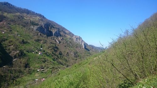 Scenic view of mountains against clear blue sky