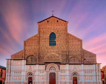 San petronio church in the piazza maggiore in bologna, italy, at sunset with dramatic  sky