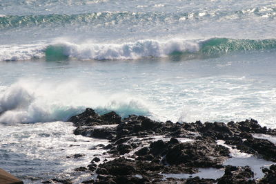 Waves splashing on rocks at shore