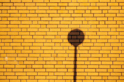 Full frame shot of yellow painted brick wall