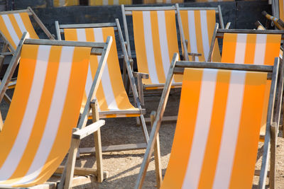 View of yellow chairs and table on sand