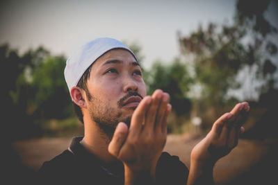 Portrait of young man smoking outdoors