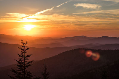 Scenic view of mountains against orange sky