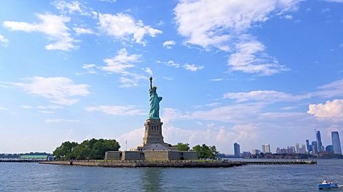 Statue of liberty against cloudy sky