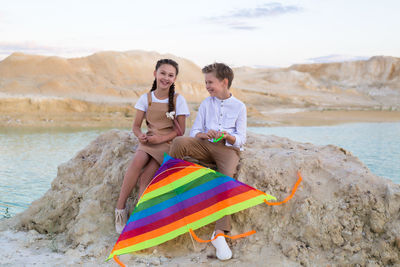 Young woman sitting on rock