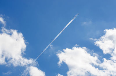 Blue sky. white clouds. trace of the plane. photo