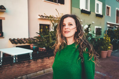 Portrait of smiling young woman standing outdoors