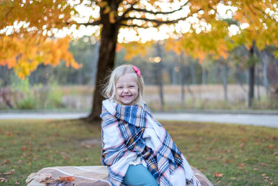 Portrait of smiling girl in park during autumn