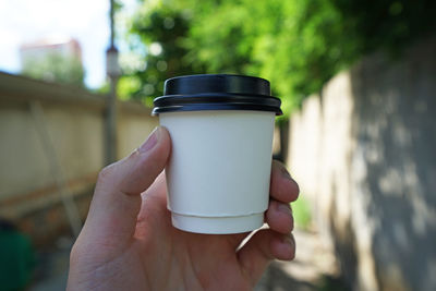 Close up hand holding hot paper cup