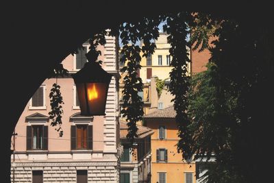 Illuminated buildings against sky during sunset