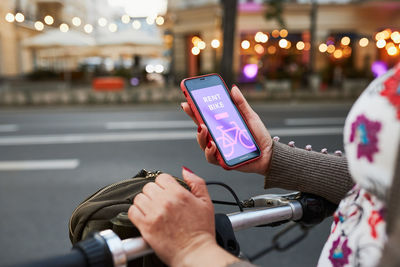 Renting bike using rental app on mobile phone. using bike sharing city service. mobile app