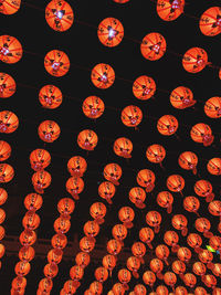 Low angle view of illuminated lanterns hanging at night