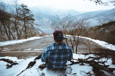 Rear view of person on snow covered field