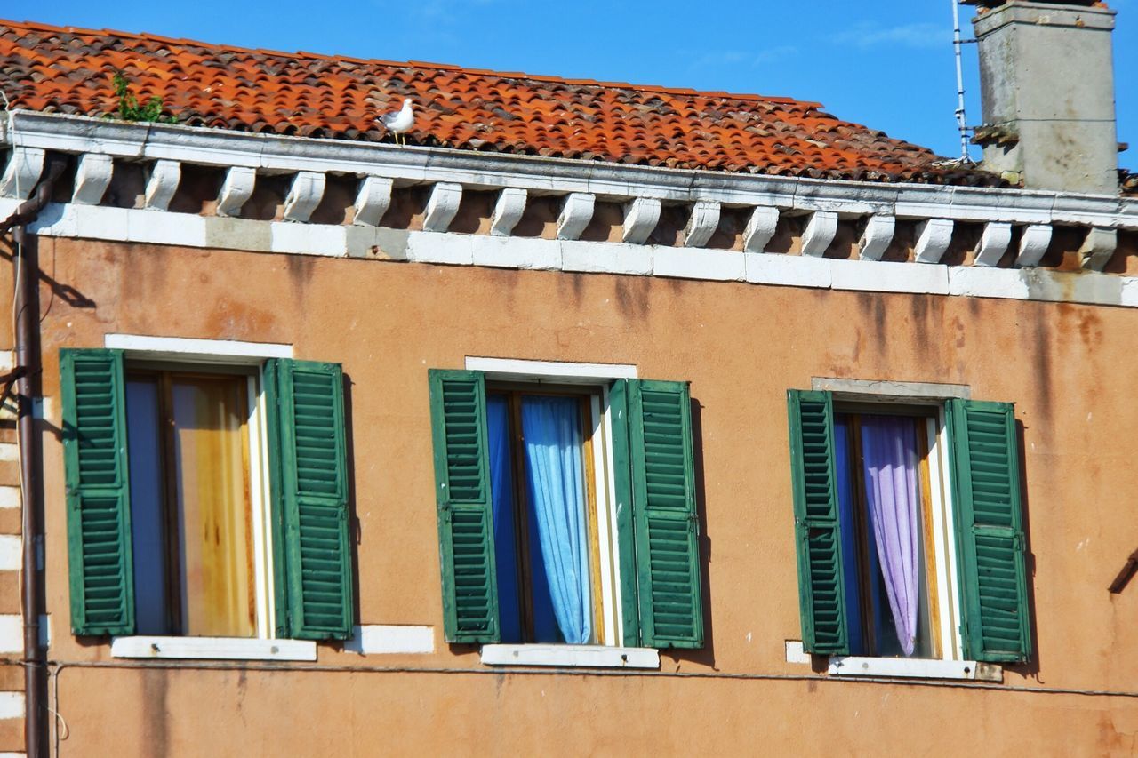 architecture, building exterior, built structure, window, low angle view, residential structure, house, residential building, balcony, building, blue, outdoors, day, sky, exterior, railing, no people, roof, facade, arch