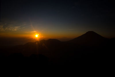 Scenic view of mountains against sky at sunset