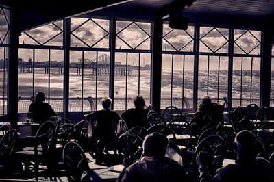 Silhouette of people in front of window