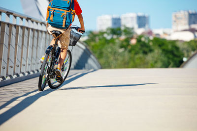 Low section of man riding bicycle on street