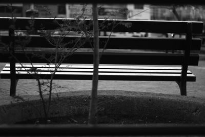 Close-up of empty bench in park