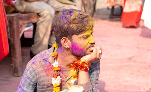 Midsection of man wearing multi colored mask