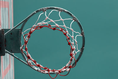 Low angle view of basketball hoop against clear blue sky during sunny day