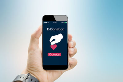 Low section of person holding smart phone