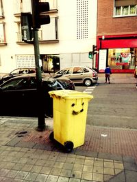 Garbage bin on street in city