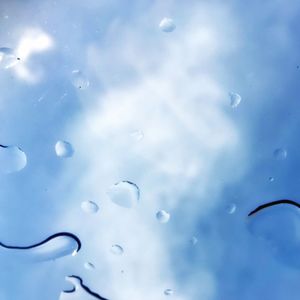 Close-up of water drops against sky