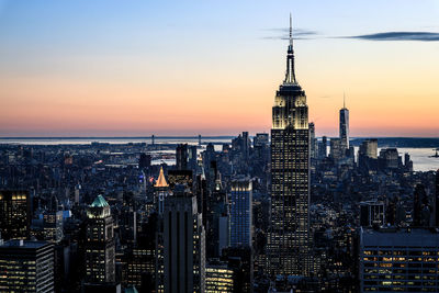 Illuminated city at sunset