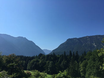 Scenic view of mountains against clear blue sky